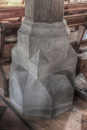 Supporting pillar base, heavily carved in a geometric design